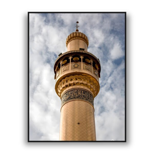 Framed wall art of a golden Islamic minaret with intricate patterns and Arabic calligraphy against a cloudy sky background.