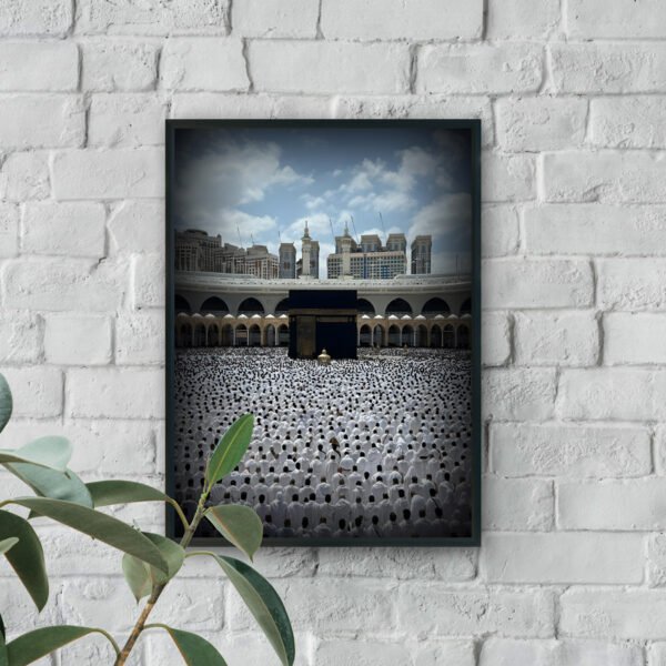 Wall art showing thousands of worshippers in white gathered around the Holy Kaaba at Masjid al-Haram under a blue sky.