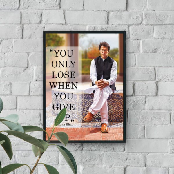 Wall art of Imran Khan sitting confidently with the quote “You only lose when you give up” displayed beside him.
