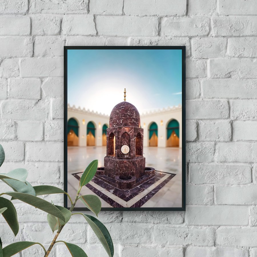 Marble domed pavilion structure centered in a mosque courtyard with arches and soft lighting in the background.